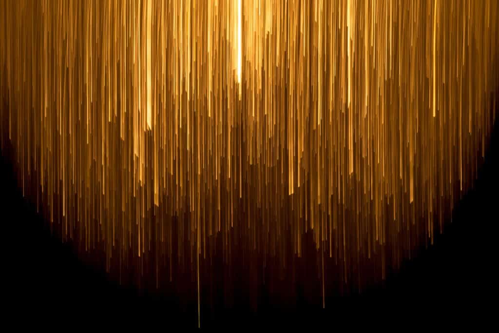 gold streams of light on black background