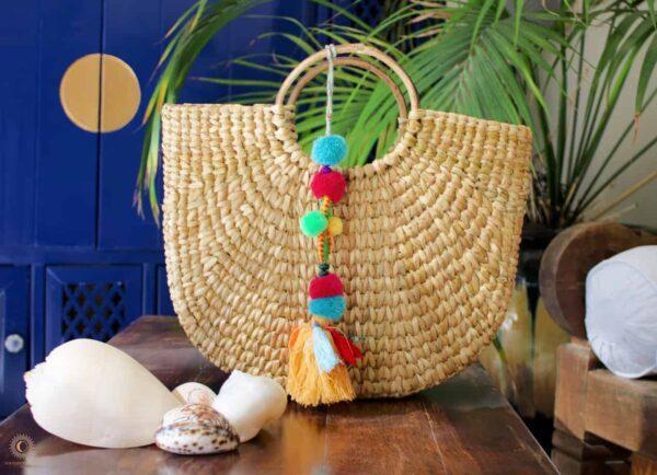 Woven basket with multi colored tassels