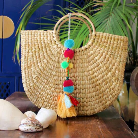 Woven basket with multi colored tassels
