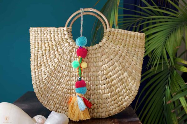 Hand woven basket with colorful tassels