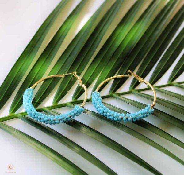 Turquoise boho hoops on fern