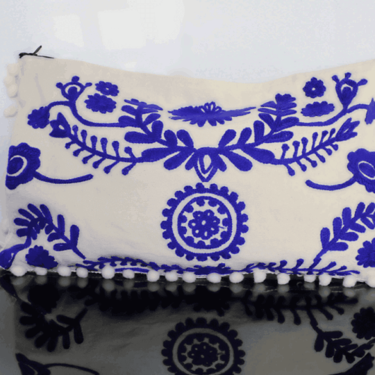 White clutch with embroidered royal blue details