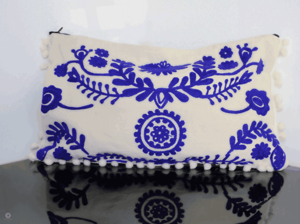 White clutch with embroidered royal blue details