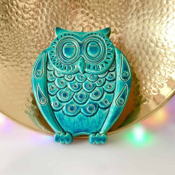 Ceramic owl pottery of an owl wall hanging tile in turquoise