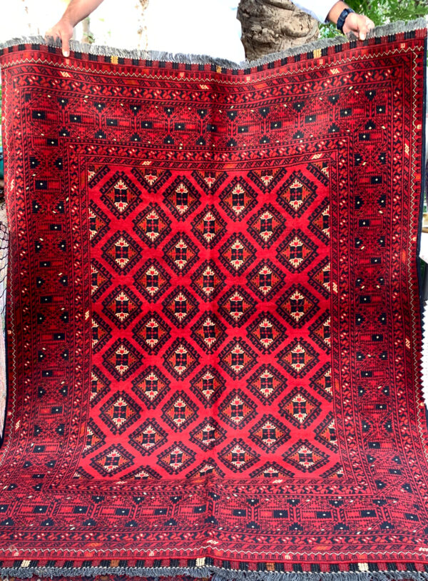 Medium Size Area Rug from Afghanistan with tribal pattern deep red