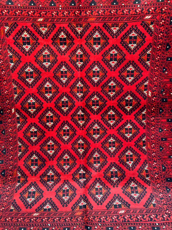 Medium size deep red rug from Afghanistan with Tribal Pattern