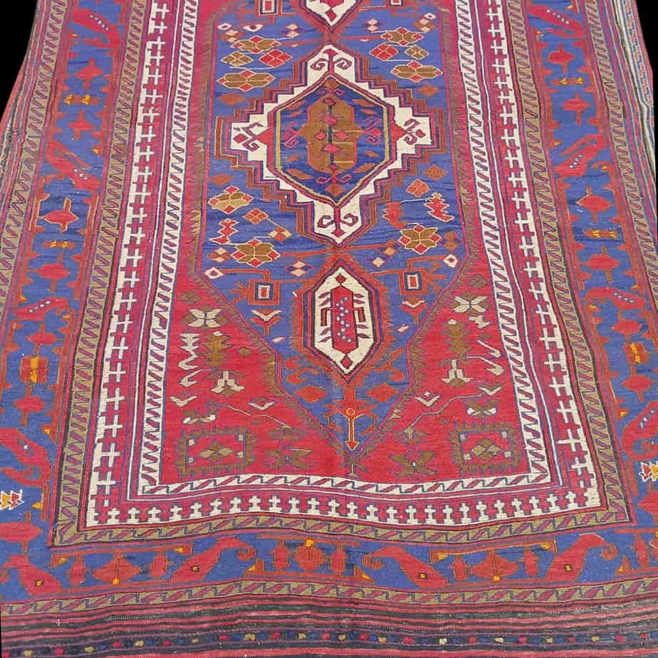 Kilim rug from Afghanistan in red blue midnight blue and white and cream, the photo shows an unclose look at the pattern of this kilim rug.