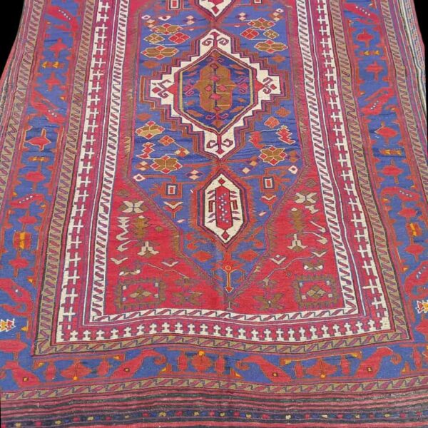 Kilim rug from Afghanistan in red blue midnight blue and white and cream, the photo shows an unclose look at the pattern of this kilim rug.