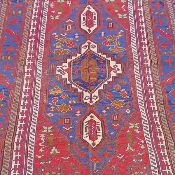 Afghani Kilim Rug with detailed central pattern the colours are midnight blue and reds.