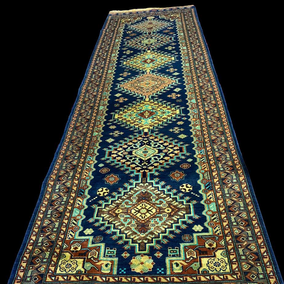 Qashqai Rug long made in Afghanistan made with silk and wool this is a tribal rug in vibrant navy, turquoise, saffron and cream.