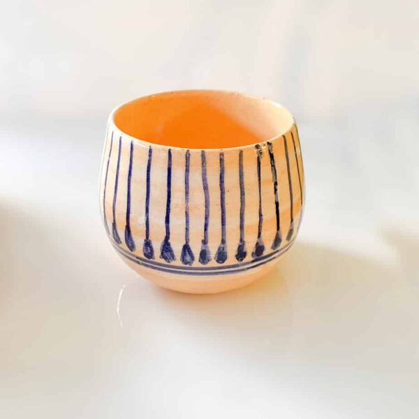 Ceramic mini pottery handmade pottery in Bahrain, has a floral background.