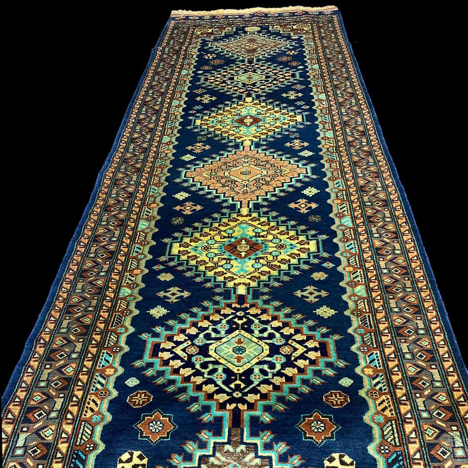 Long Qashqai runner made with silk and wool the colours are vibrant shades of navy, turquoise saffron and cream.