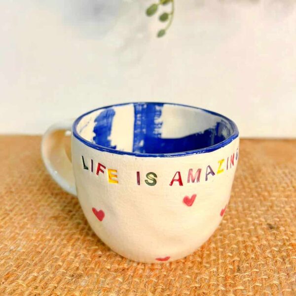 Handmade Ceramic mug and it has painted words life is beautiful