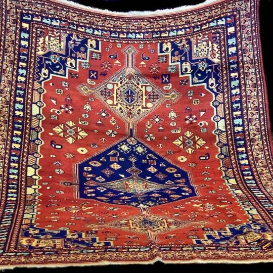 Large vintage persian rugs with detailed borders and colourful bring central portion.