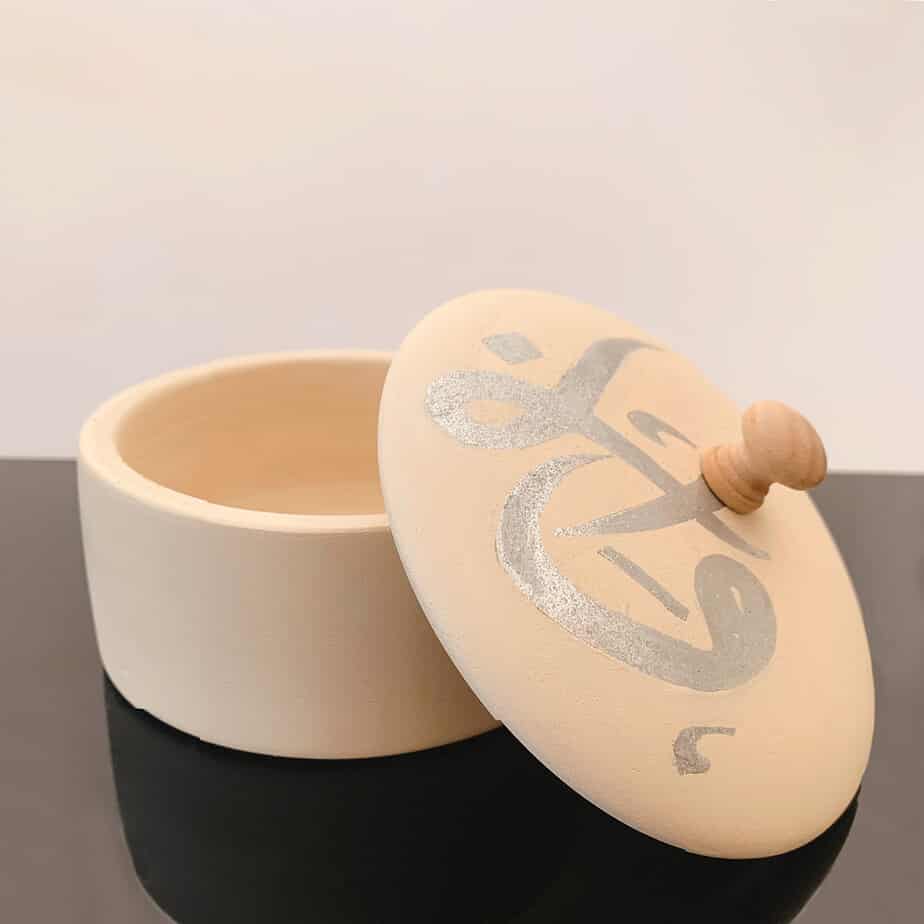 Ceramic Pottery Container with silver metallic script on the lid