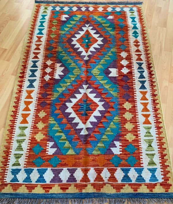 Handmade kilim rug from Afghanistan - with tribal prints this is medium size area rug.