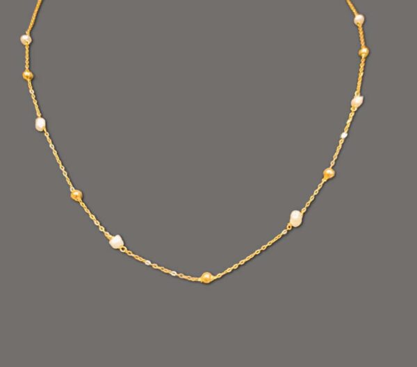 Gold chain that contains gold spheres. Modern style gold and pearl necklace.