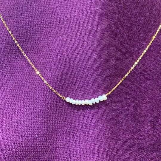 Gold ad Pearl Chain Necklace with pearls layered and positioned in the centre of the necklace.