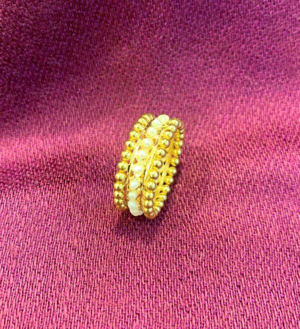 Ring made with triple row of gold and real pearls.