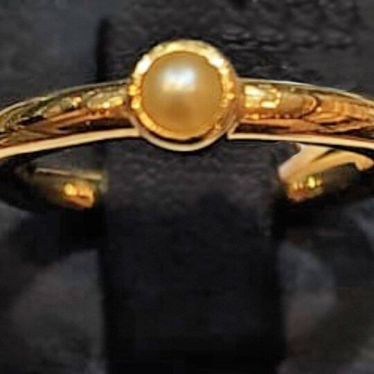 single pearl and gold ring with a modern design