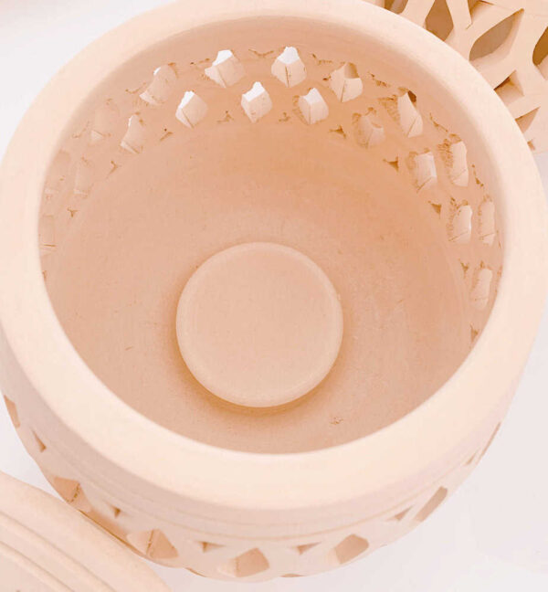 Decorative wooden candle holder with intricate cut-out design, perfect for home decor and creating a warm ambiance.