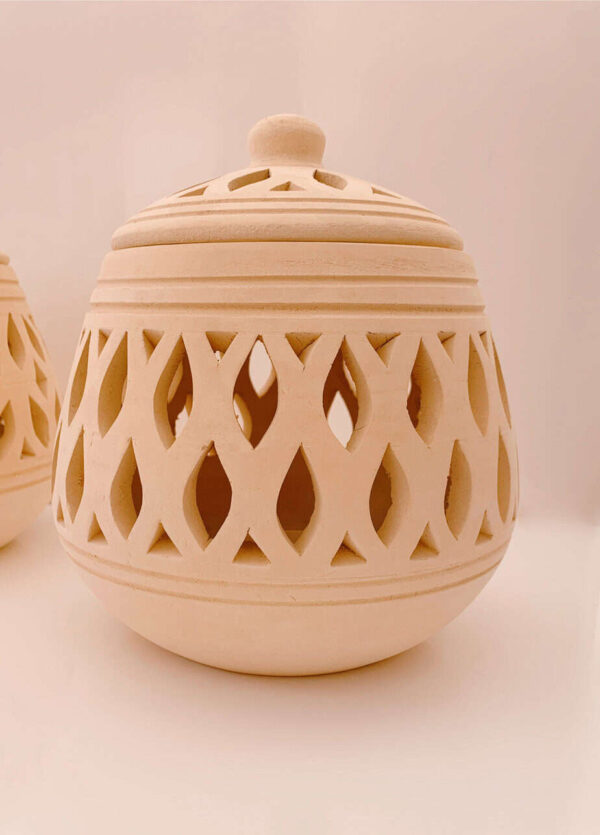 Elegant wooden jar with intricate cut-out patterns and a lid, ideal for home decoration or storing small items. Crafted from high-quality wood, showcasing traditional design and craftsmanship.