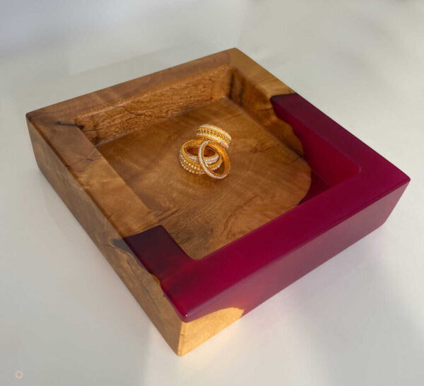 Wooden jewellery box with a pair of gold rings inside, showcasing luxury and craftsmanship. Perfect for storing rings, earrings, and small accessories.