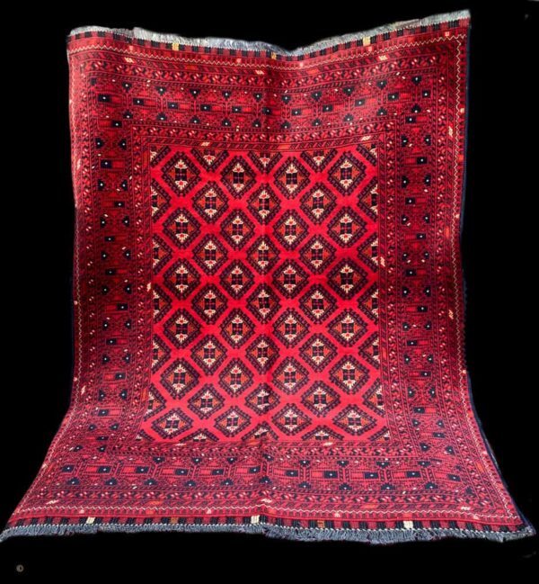 Red geometric patterned rug with intricate designs, ideal for enhancing interior decor and adding cultural elegance to living spaces.