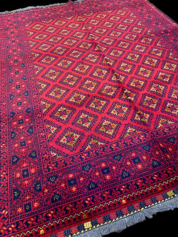 Persian rug featuring intricate geometric patterns in vibrant red, blue, and yellow colours, showcasing detailed craftsmanship and traditional design elements.