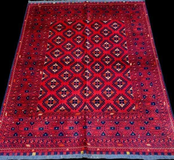 Persian rug with intricate geometric patterns in vibrant red, blue, and beige colours, ideal for enhancing living room or bedroom aesthetics.