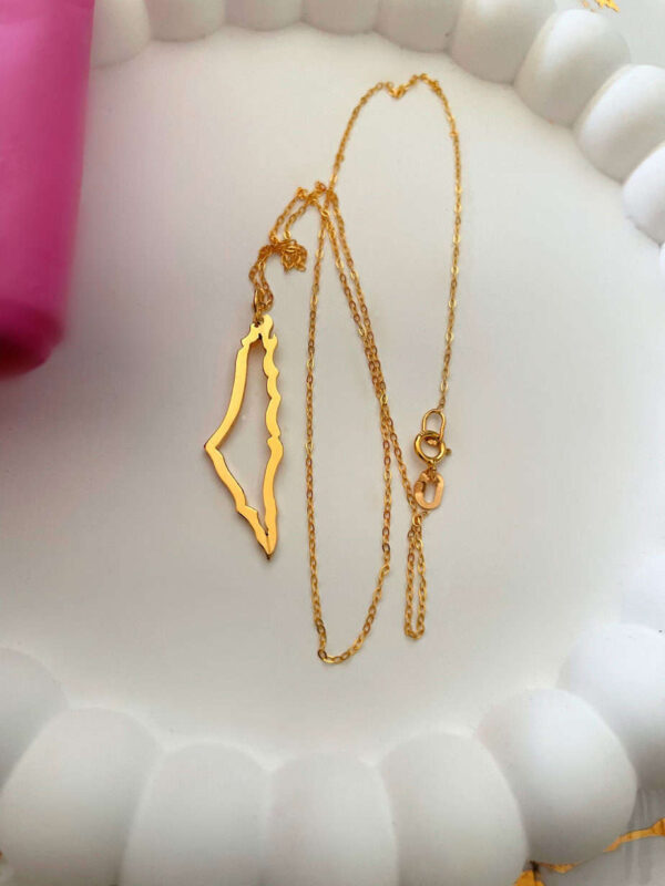 Gold necklace featuring a map-shaped pendant, perfect for stylish women. Crafted with high-quality materials, ideal for everyday wear or special occasions.