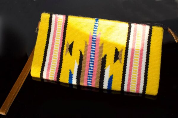 Colourful handwoven yellow clutch bag featuring intricate traditional patterns, perfect for casual or festive occasions, showcasing craftsmanship and cultural design.