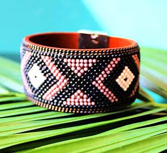 Beaded tribal bracelet with intricate geometric patterns, traditional African accessories, handmade jewellery, colourful beadwork, cultural fashion.