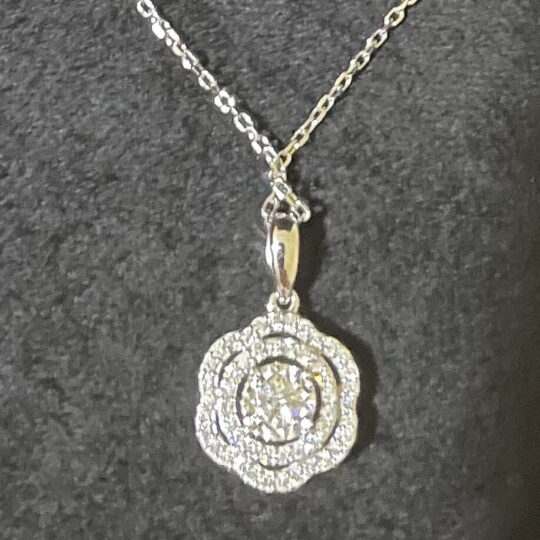 Shiny silver and gold necklace with sparkling diamond-encrusted pendant, elegant jewellery accessory, perfect for special occasions or everyday wear.