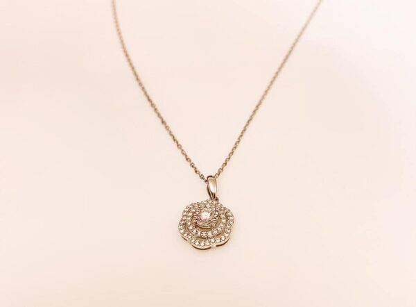 Delicate gold necklace with a sparkling diamond-encrusted floral pendant for elegant jewellery accessories.