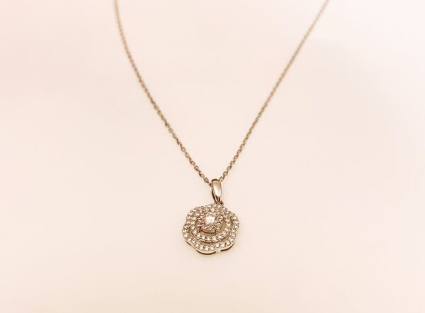 Delicate gold necklace with a sparkling diamond-encrusted floral pendant for elegant jewellery accessories.