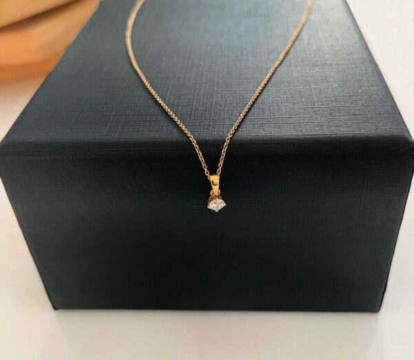 Shiny gold necklace with diamond pendant on black gift box, luxury jewellery, elegant accessories for women.