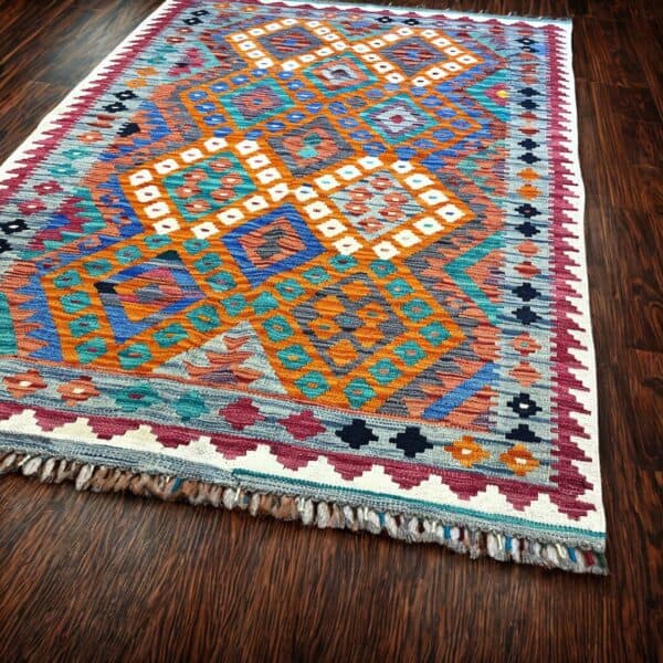 Handwoven Artisan Rug created in Afghanistan, this tribal rug achieved the vibrant colours from natural dyes only