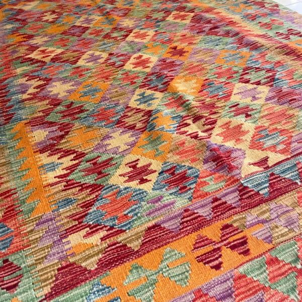 A traditional rug made using the traditional kilim, this handmade rug hails from Afghanistan.