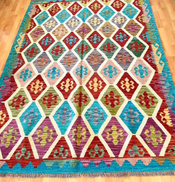 large handmade rug, created with the kilim it has very colourful patterns in Turqoise and red.