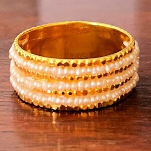 A gold ring with 3 layers of natural pearls