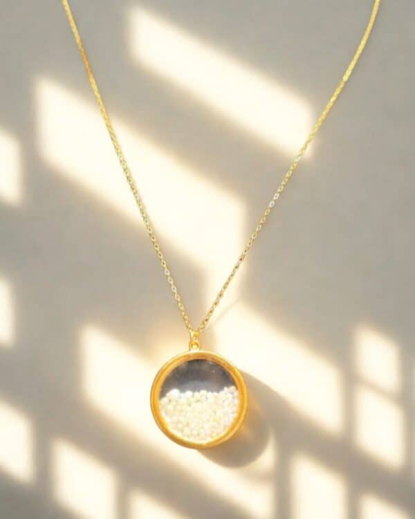 A gold pendant, inside the pendant are lots of natural pearls from Bahrain.