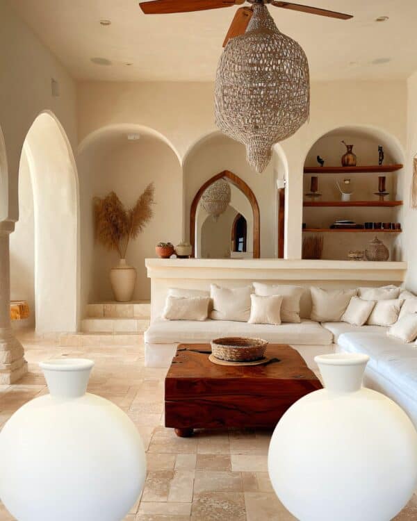 2 Extra Large White pottery vases set in an Elegant bohemian living room with neutral tones, woven pendant lights, and decorative shelving, creating a cosy and stylish interior for modern home comfort.