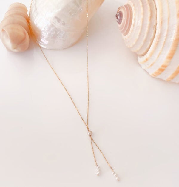 Elegant gold necklace with pearl accents, perfect for summer accessories and beachwear, available at Souq2Door jewellery collection.