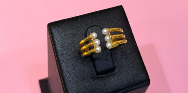 Elegant gold ring with pearl accents, perfect for stylish occasions and accessories. Contains natural pearls from Bahrain.