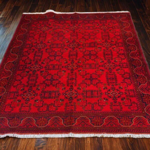 Rich red traditional hand-knotted wool rug from Afghanistan featuring intricate geometric patterns, floral motifs, and a decorative border. Perfect for enhancing the style of living rooms, lounges, or ethnic home decor.
