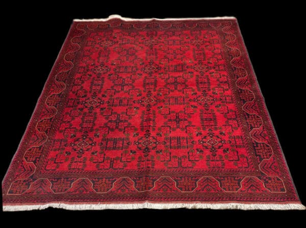Luxurious red rug featuring intricate black and gold geometric designs, ideal for enhancing home décor with a touch of elegance and cultural richness. Oriental Rug from Afghanistan with Natural Dyes, hand knotted art. Khal Mohammed rugs are highly sought