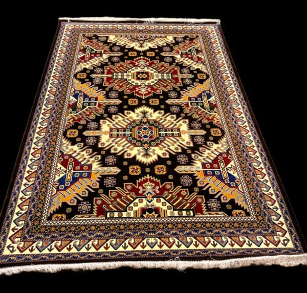 Detailed image of a traditional Silk Persian oriental rug with vibrant colours including black, red, cream, blue, and yellow, showcasing exquisite craftsmanship and decorative design elements for home decor.