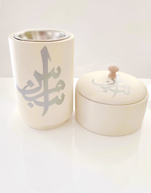 Elegant cream Bahrain pottery duo with Arabic calligraphy. Both pieces of pottery contain Arabic Calligraphy which is hand-painted. Contains a bakhoor burner for oud and a cute pot with lid.