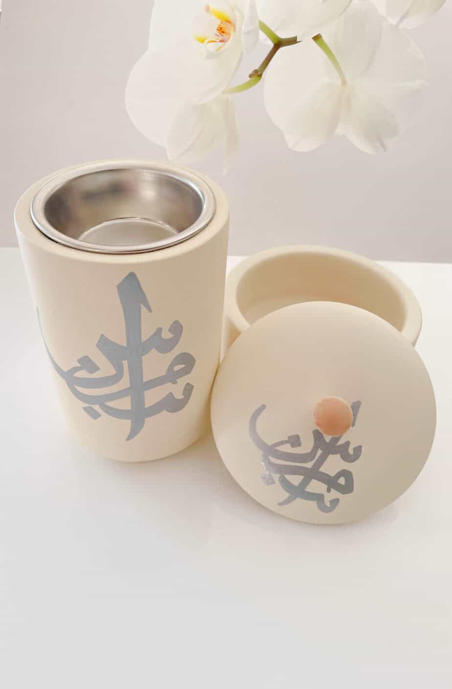 Bahrain Pottery, Bakhoor Burner with Arabic design and stainless steel interior to burn oud. The pottery is cream with handprinted Arabic Calligraphy.
